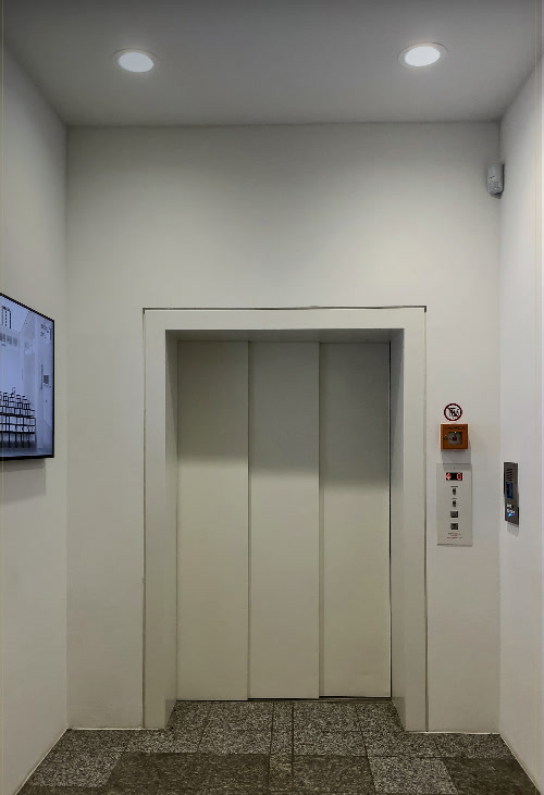 Passenger lift with closed doors in a building lobby