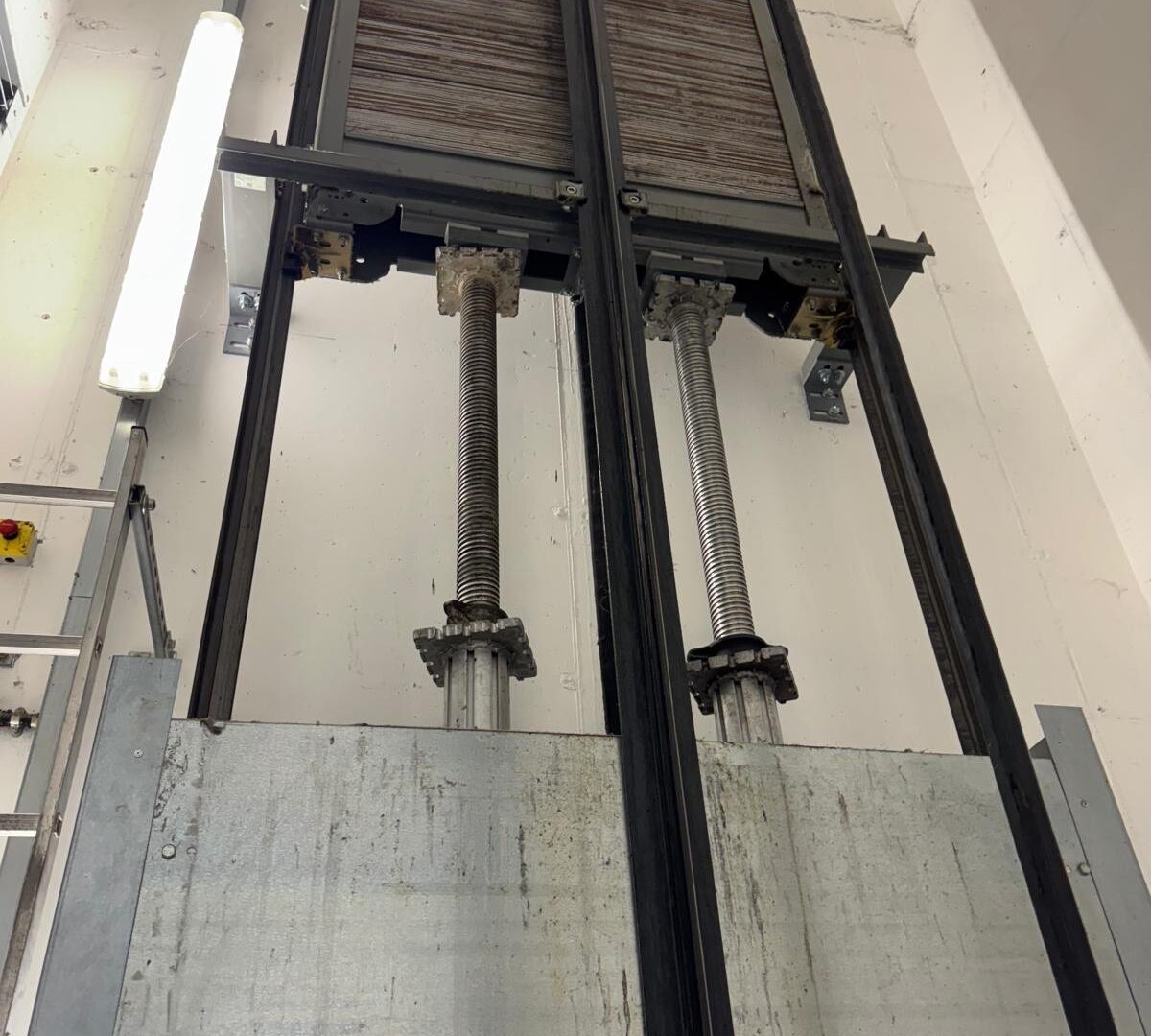 Hydraulic lift equipment and guide rails inside a lift shaft