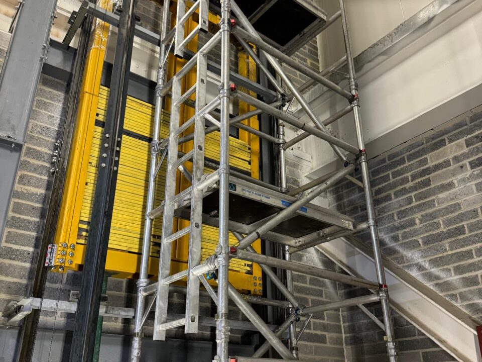 Scaffold access beside a lift car in a shaft